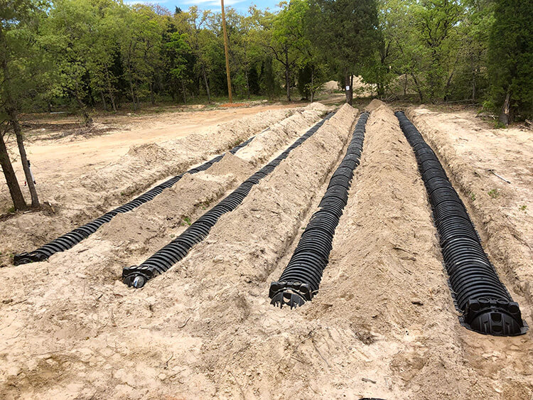 Drain field piping being repaired
